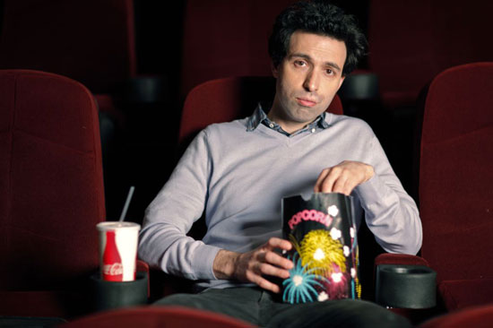 Filmmaker Alex Karpovsky eating popcorn