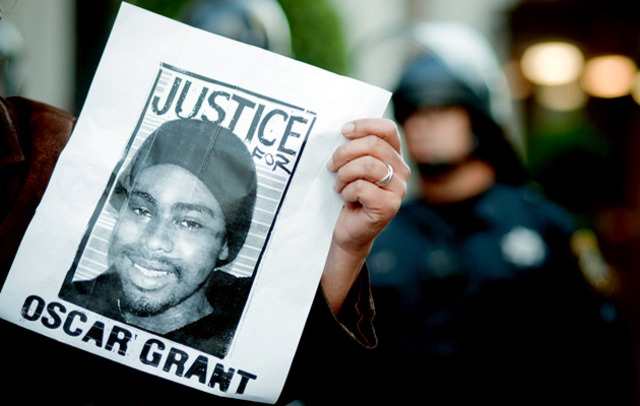 Protester with Oscar Grant flyer