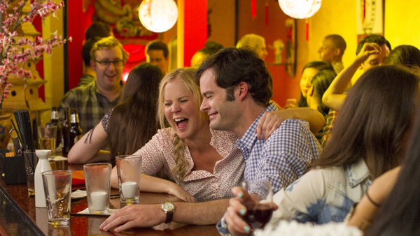 Bill Hader as Aaron and Amy Schumer as Amy in Trainwreck