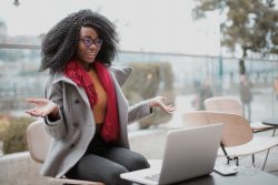 Woman smiling in front of her laptop